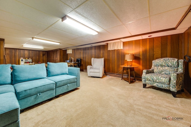 living room with a drop ceiling and carpet