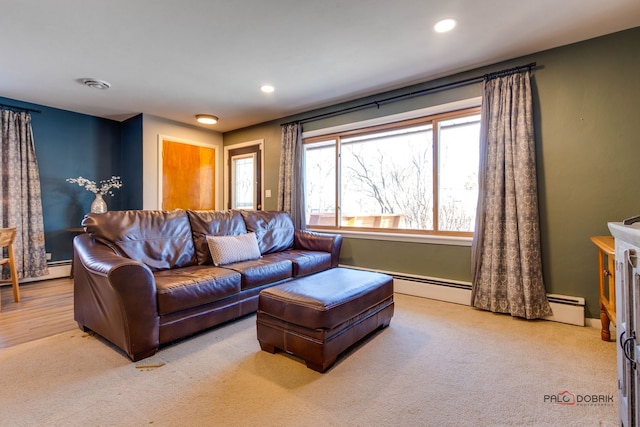 living room with baseboard heating and light colored carpet