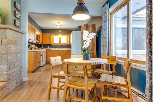 kitchen featuring sink, white appliances, and light hardwood / wood-style floors