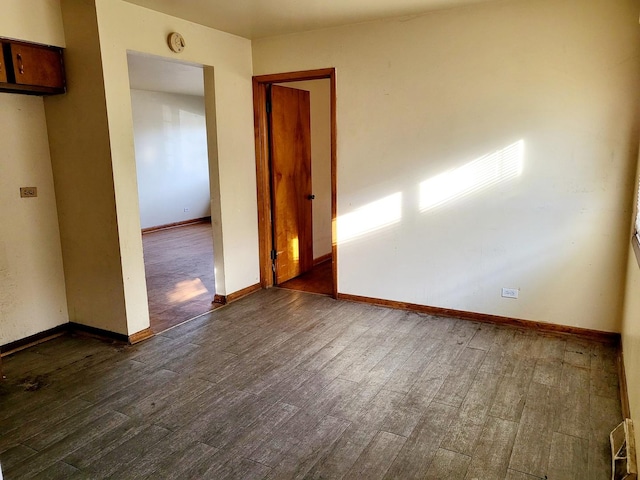 unfurnished room with dark hardwood / wood-style floors