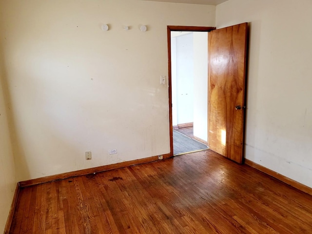 unfurnished room with hardwood / wood-style flooring