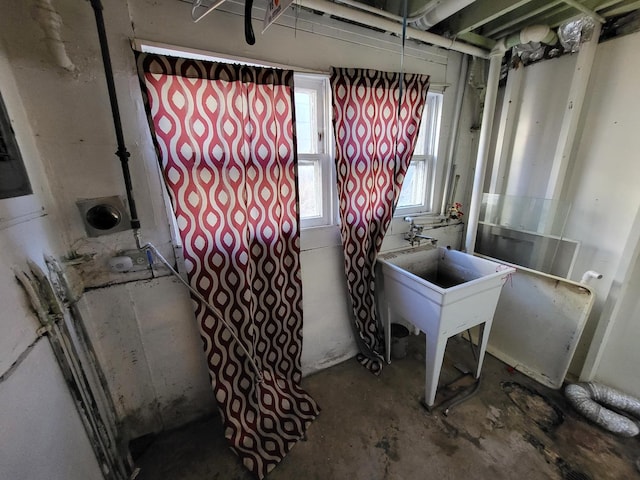 clothes washing area with a wealth of natural light and sink