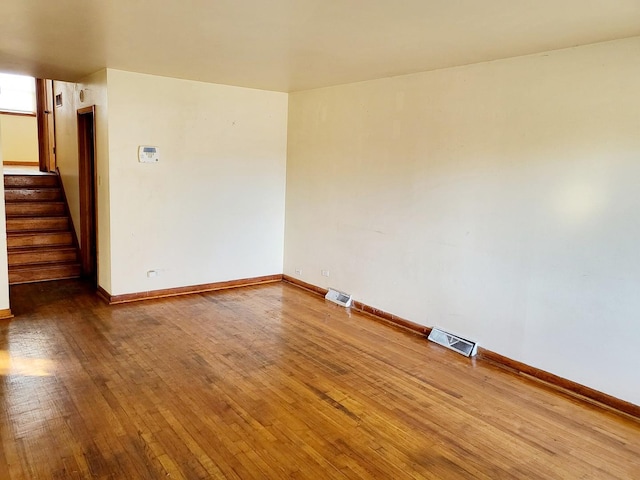 spare room with hardwood / wood-style floors