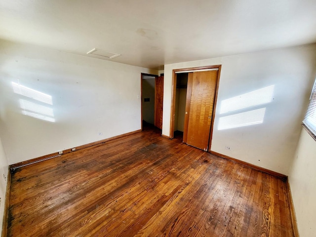 unfurnished bedroom featuring dark hardwood / wood-style floors