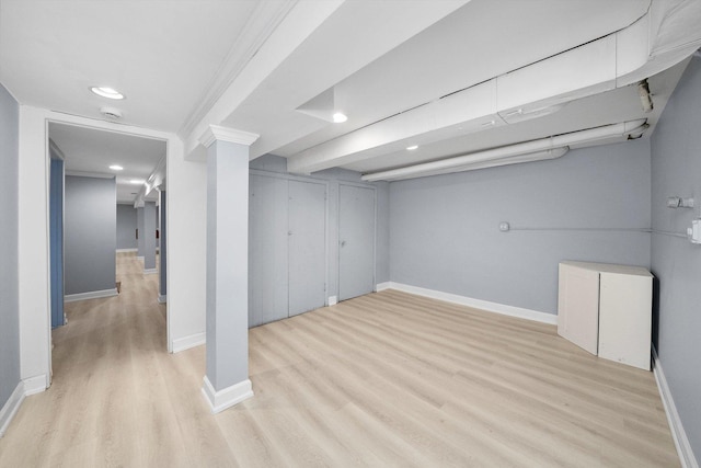 basement with light wood-type flooring and crown molding