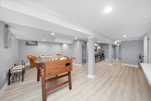 recreation room featuring crown molding and light wood-type flooring