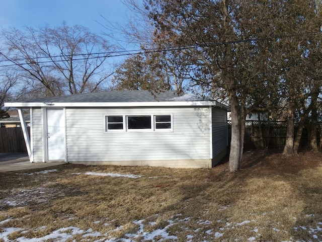 snow covered structure with a yard