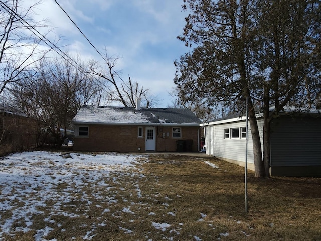 snow covered property with a yard