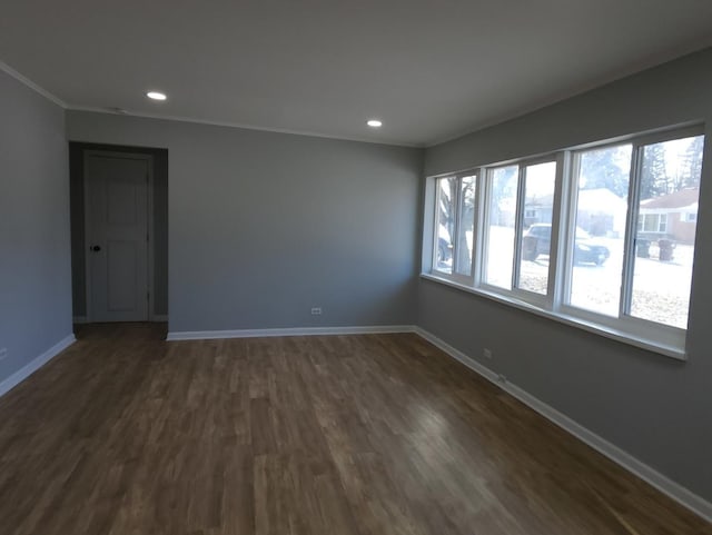 spare room with plenty of natural light and dark hardwood / wood-style flooring