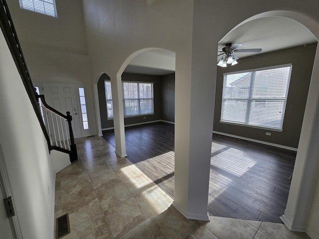 entrance foyer with light tile patterned floors and ceiling fan