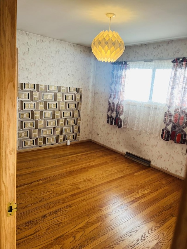 empty room with hardwood / wood-style floors