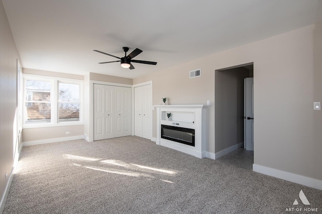 unfurnished living room with carpet floors and ceiling fan