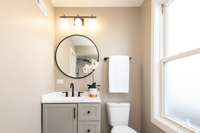 bathroom featuring toilet and vanity