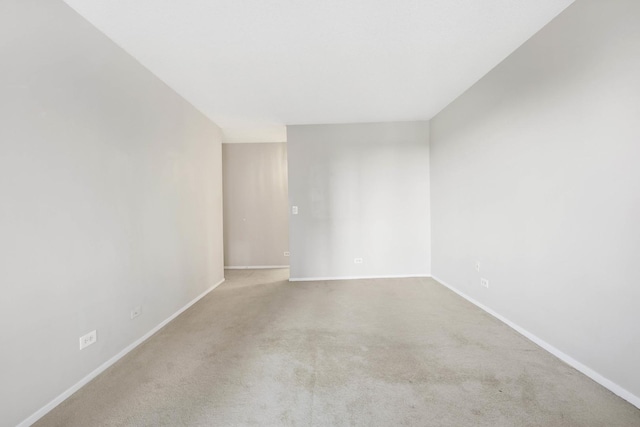 unfurnished room featuring light colored carpet