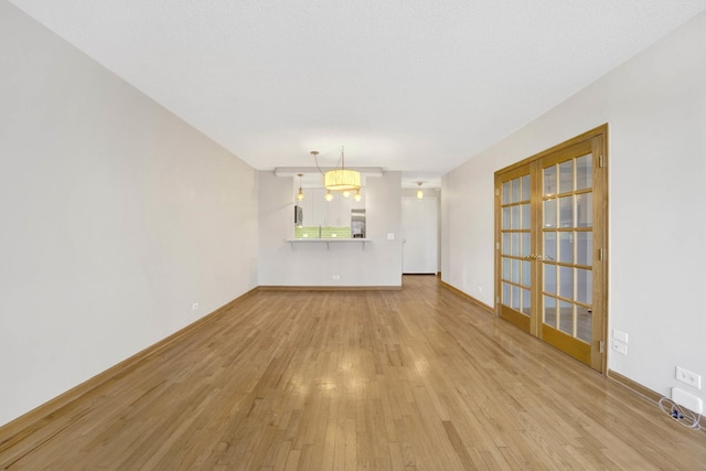 unfurnished living room with light wood-type flooring