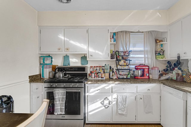 kitchen featuring gas range, white cabinets, and white dishwasher