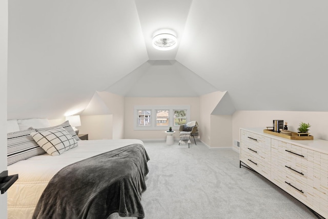 bedroom featuring light colored carpet and lofted ceiling