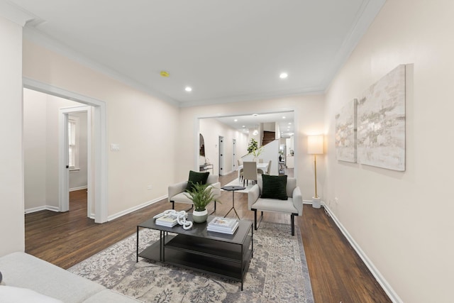 living room featuring dark hardwood / wood-style flooring and crown molding