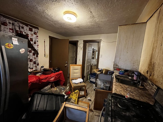 miscellaneous room with sink and a textured ceiling