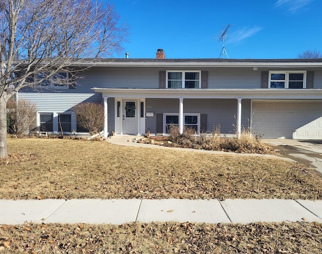 view of front of property with a garage and a front lawn