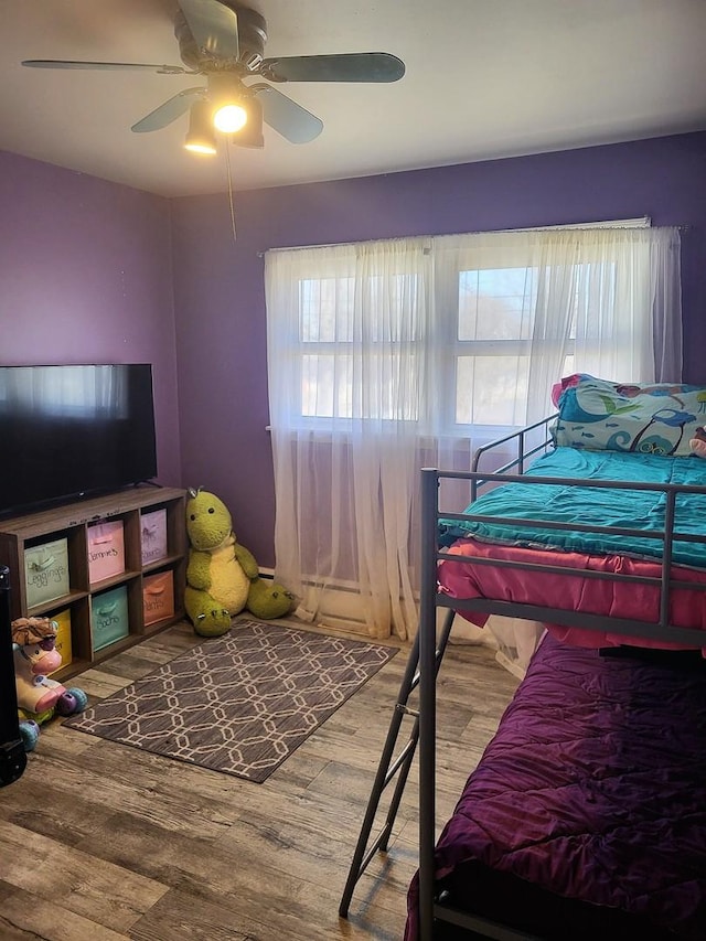 bedroom with hardwood / wood-style floors and ceiling fan