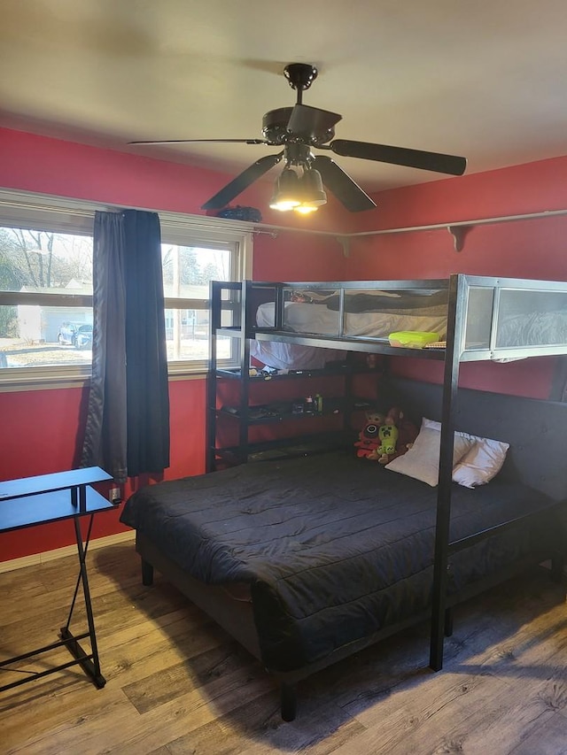 bedroom featuring wood-type flooring and ceiling fan