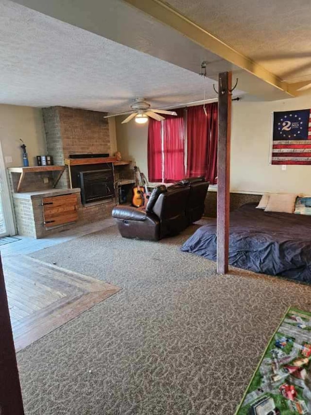 carpeted living room featuring a brick fireplace, a textured ceiling, and ceiling fan