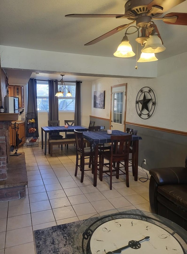 tiled dining room with ceiling fan