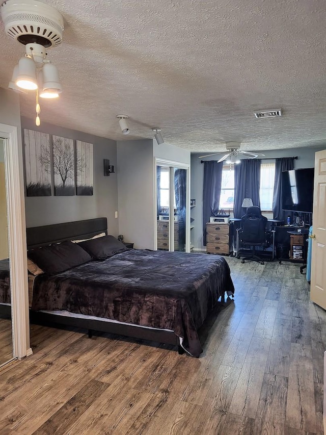 bedroom featuring hardwood / wood-style flooring and a textured ceiling