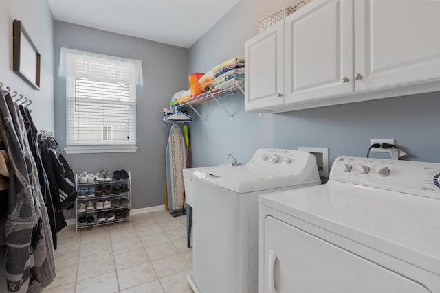 laundry room featuring light tile patterned flooring, cabinets, and washer and dryer