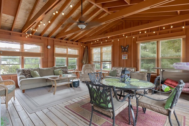 sunroom with vaulted ceiling with beams, plenty of natural light, and wooden ceiling