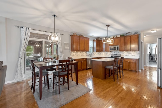 dining space featuring a notable chandelier and light wood-type flooring