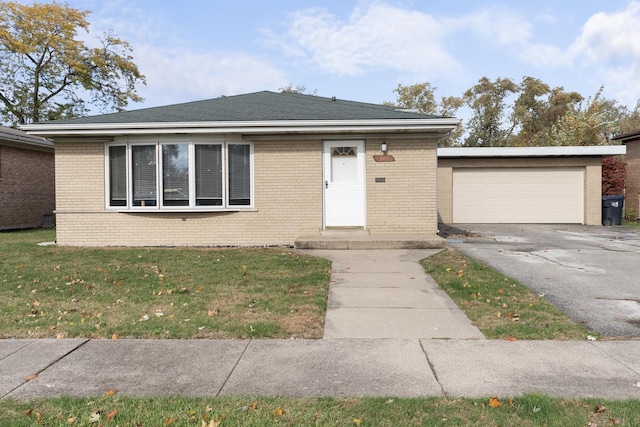 ranch-style home with a garage and a front lawn