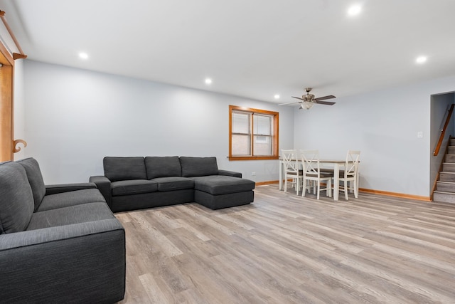 living room featuring ceiling fan and light wood-type flooring