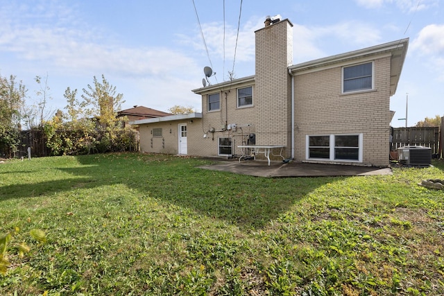 rear view of property featuring a patio area, central AC unit, and a yard