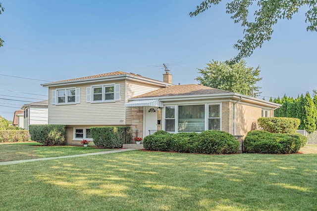 split level home with a front yard