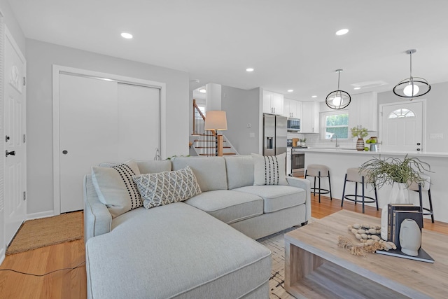 living room with sink and light hardwood / wood-style floors