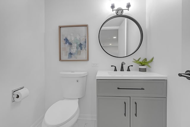 bathroom featuring toilet and vanity