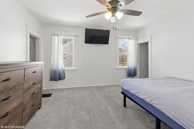 bedroom with visible vents, baseboards, ceiling fan, and light colored carpet