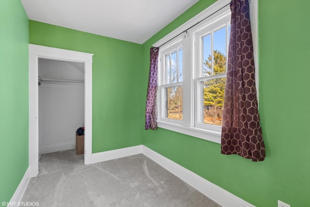 unfurnished bedroom featuring carpet, baseboards, and a closet