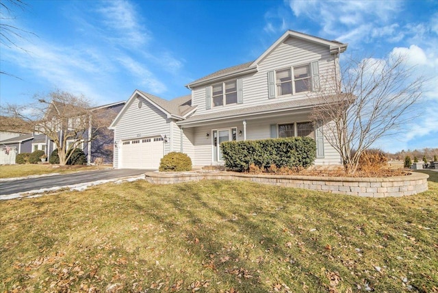 view of front property featuring a garage and a front lawn