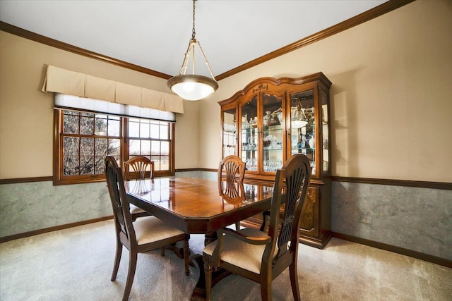 carpeted dining space featuring crown molding