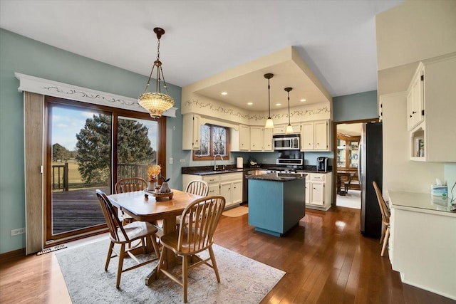 dining room with sink and dark hardwood / wood-style floors