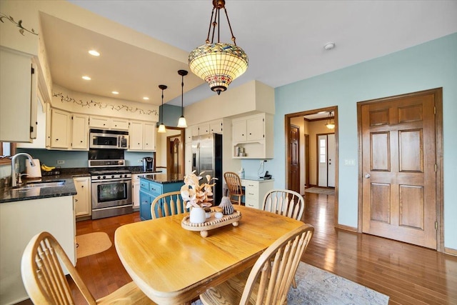 dining area with dark hardwood / wood-style flooring and sink