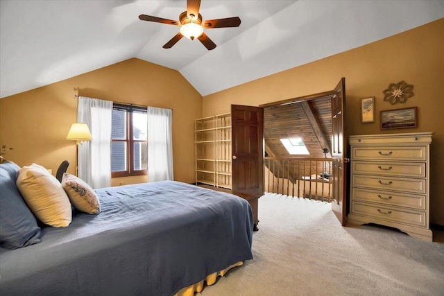 carpeted bedroom featuring ceiling fan and lofted ceiling with skylight