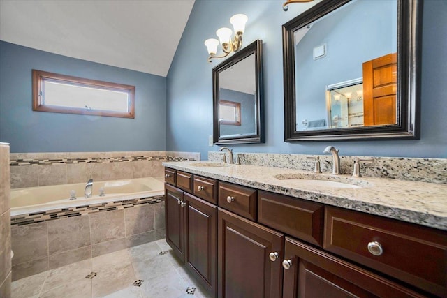 bathroom with vanity, lofted ceiling, tile patterned floors, and a relaxing tiled tub