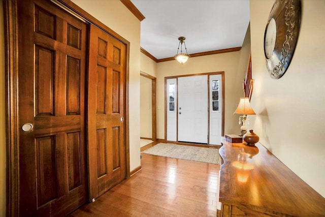 entrance foyer with wood-type flooring and crown molding