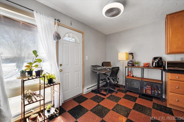 home office with a baseboard radiator and a textured ceiling