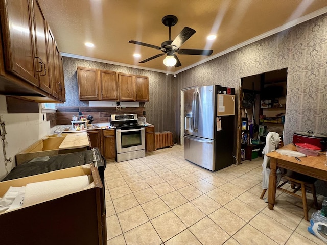 kitchen featuring light tile patterned floors, crown molding, stainless steel appliances, and ceiling fan