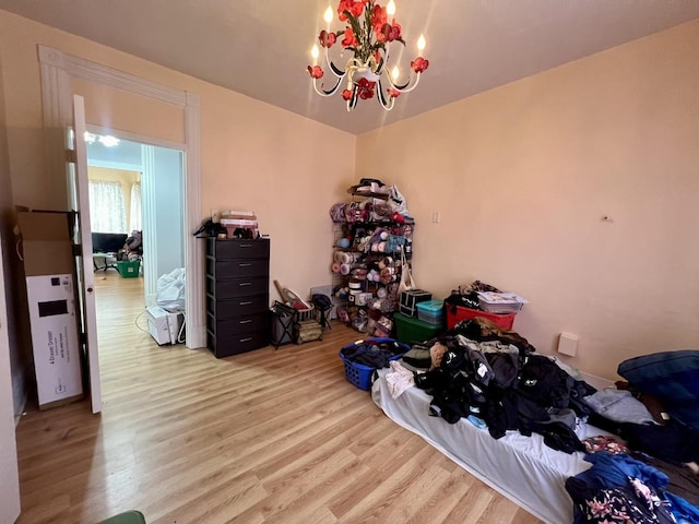 misc room featuring an inviting chandelier and light hardwood / wood-style floors